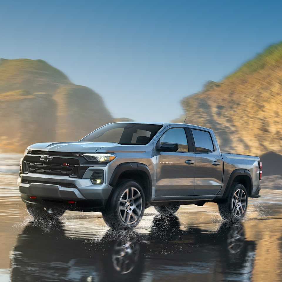 The Chevy Colorado Driving Along the Shore at Sunrise