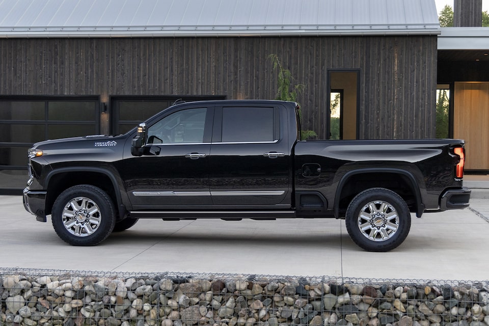 The 2024 Black Silverado HD Displayed Outside of A Modern Ranch Home