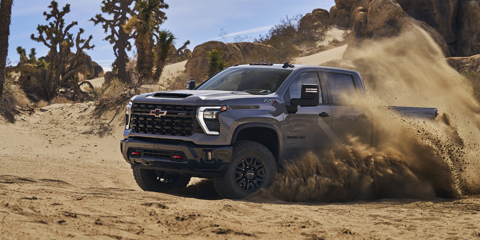 2025 Gray Chevy Silverado Heavy Duty off roading in the sand