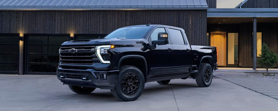 The Black 2024 Silverado HD Parked Outside of a Modern Ranch Style Home