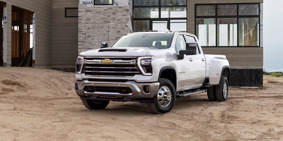 Front 3/4 View of Summit White 2024 Silverado HD on Job Site