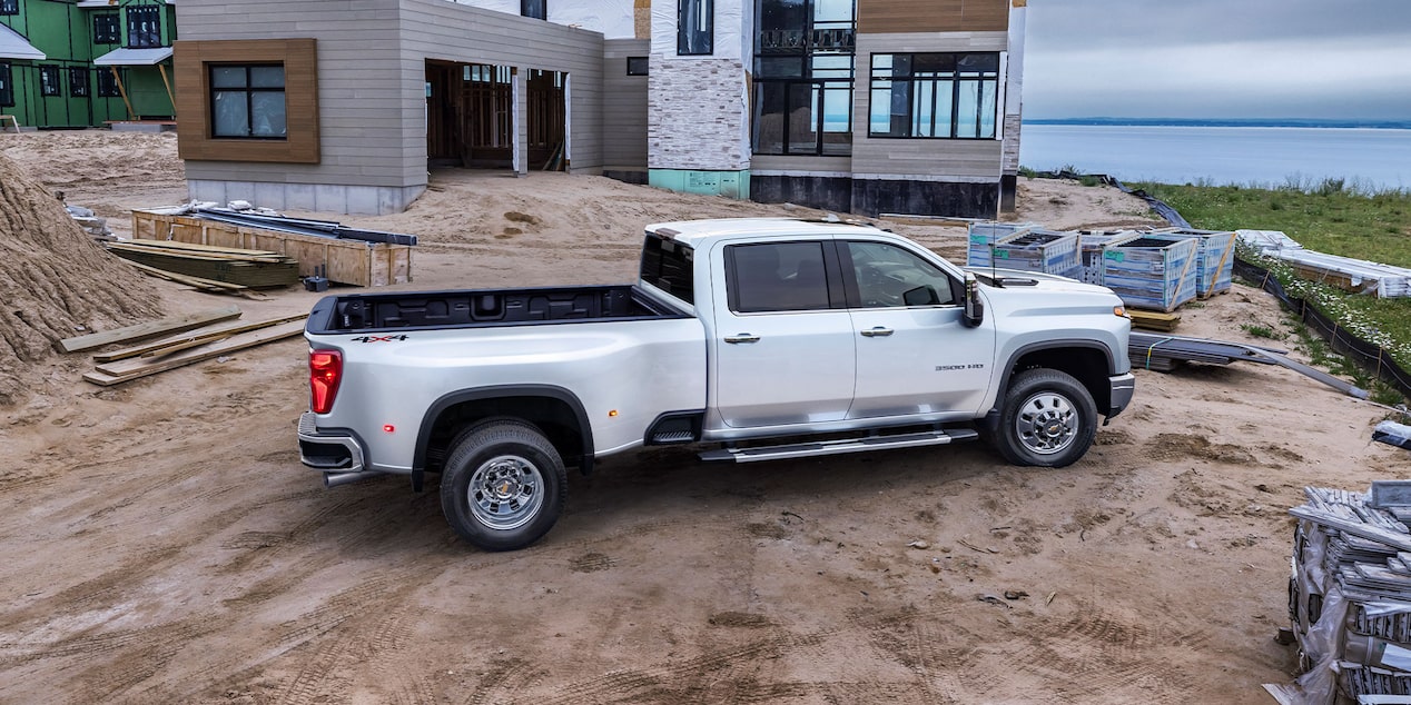 Passenger Side View of The Summit White Silverado HD On the Jobsite 