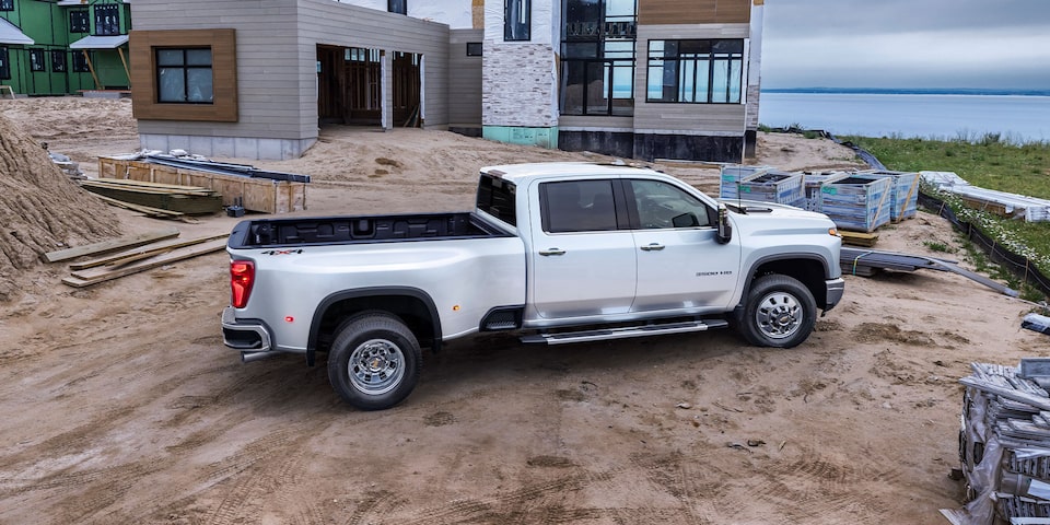 Passenger Side View of The Summit White Silverado HD On the Jobsite 