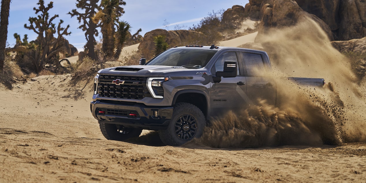 Driver's Side of Silverado HD ZR2 Driving in Dirt