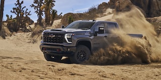 Driver's Side of Silverado HD ZR2 Driving in Dirt