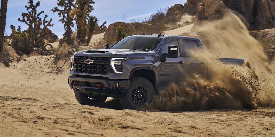 Driver's Side of Silverado HD ZR2 Driving in Dirt