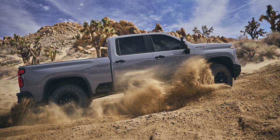 Passenger Side of Silverado HD ZR2 Driving in Dirt