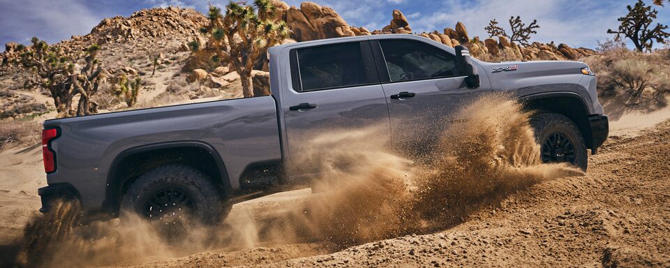 Passenger Side of Silverado HD ZR2 Driving in Dirt
