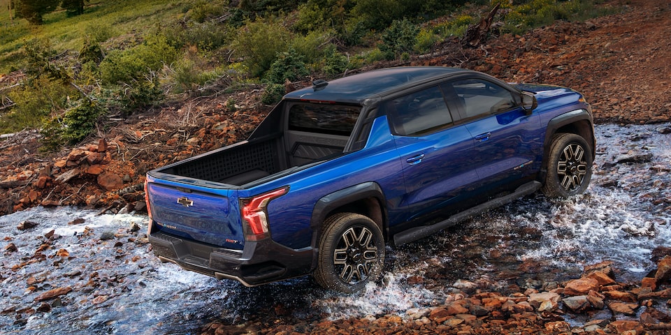2024 Silverado EV Driving Over Stream of Water