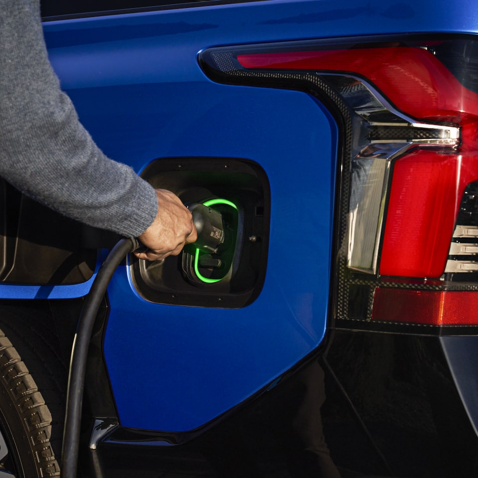 Driver Plugging In Their 2024 Silverado EV Into The Charging Port