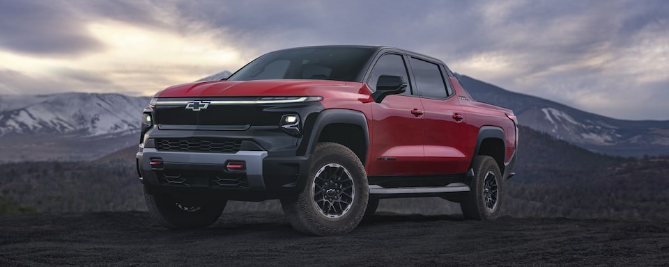 2024 Chevy Silverado EV Trail Boss Parked Fiercely In Front Of Mountains 