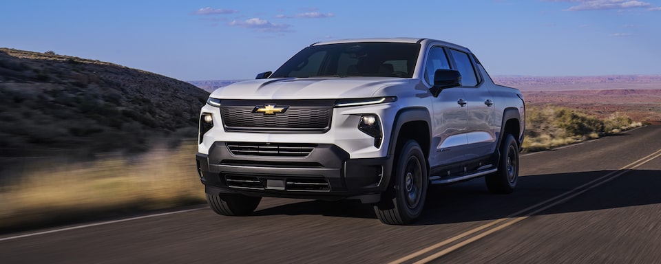 2024 Chevy Silverado EV Work Truck Driving Down A Nature Scenic Road