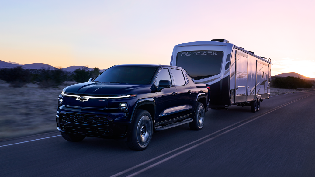 Chevy Silverado EV Towing a RV Down an Open Road
