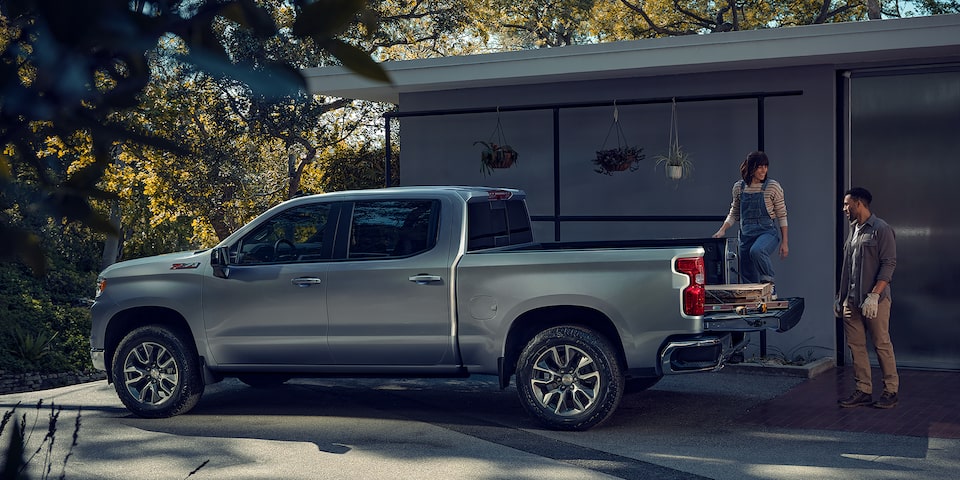 Couple Loading Supplies Into the Back of a Chevrolet Silverado 1500
