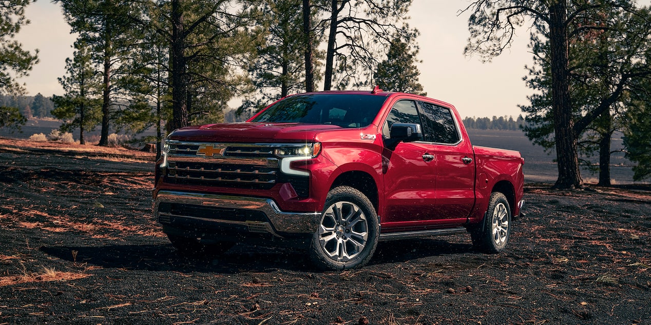 Red 2024 Chevrolet ZR1 Silverado parked in a lighted Forrest