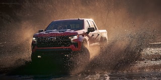 Chevrolet Silverado 1500 Pickup Truck Driving Through Wet Terrain