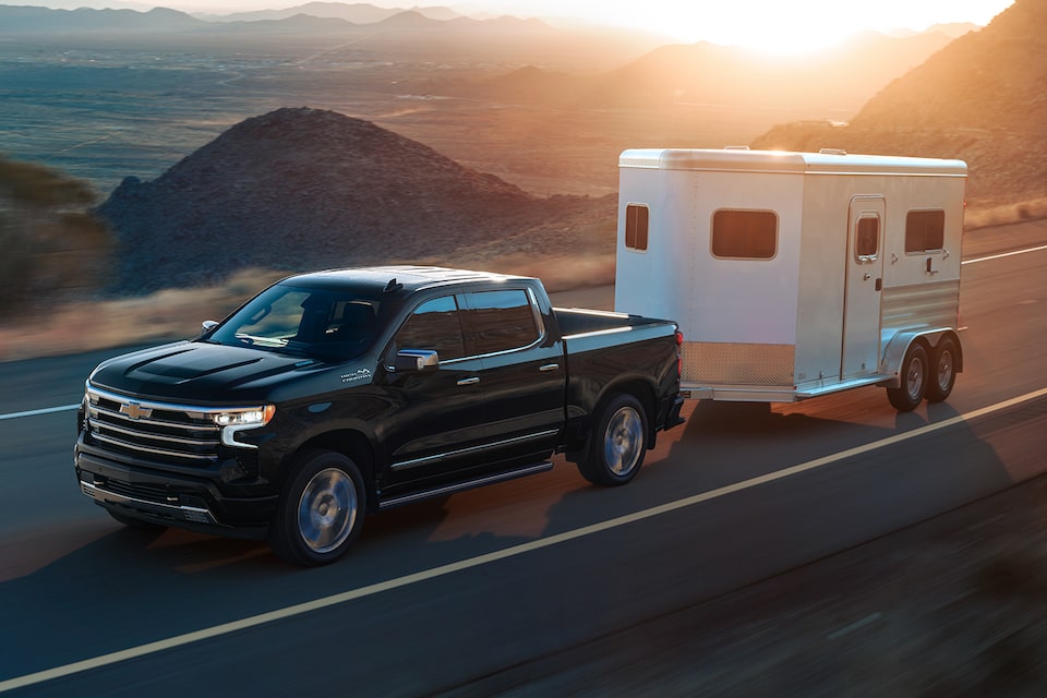 The 2024 Silverado Towing a Trailer on an Open Road