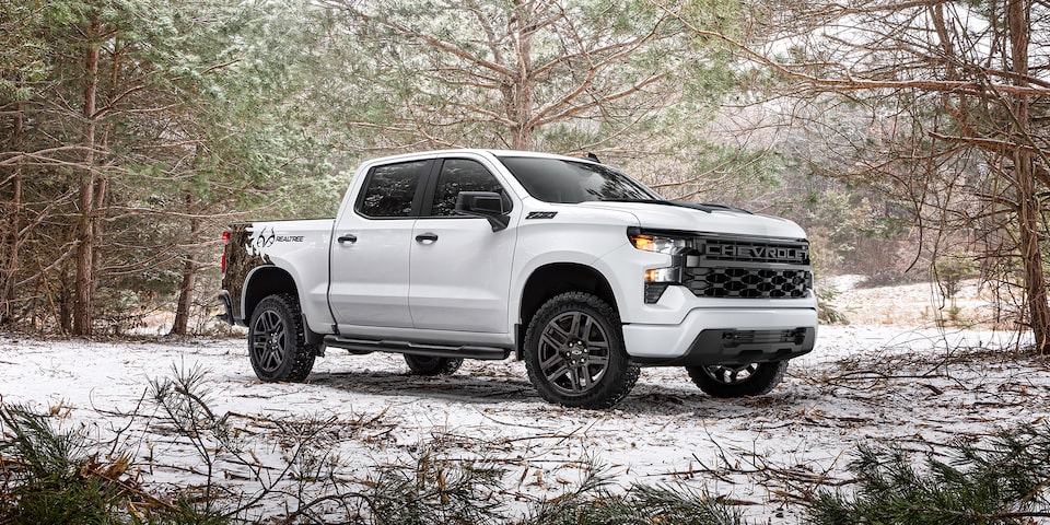 The 2024 Silverado Parked in the Woods During Winter