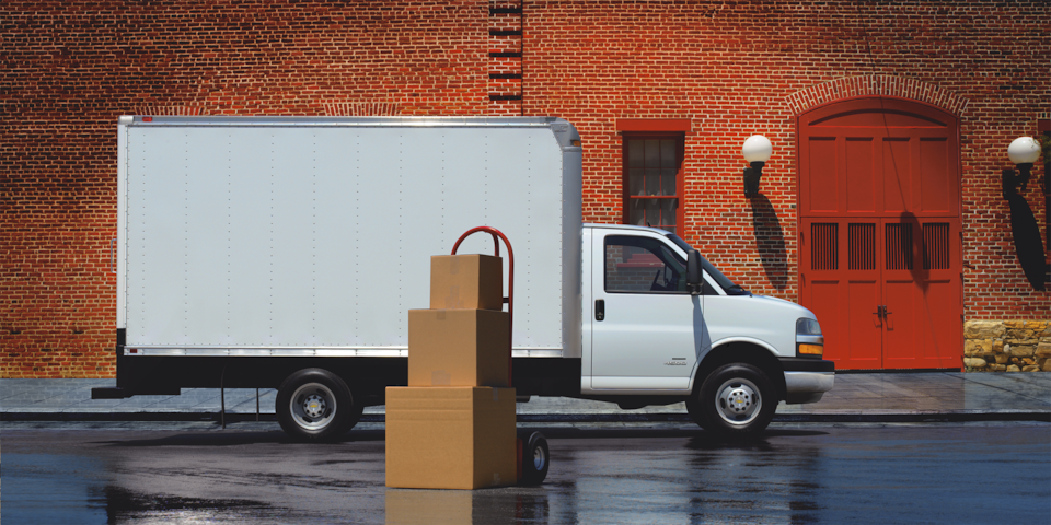 Side Profile of The 2025 Chevy Express Cutaway With Boxes Stacked Beside Vehicle