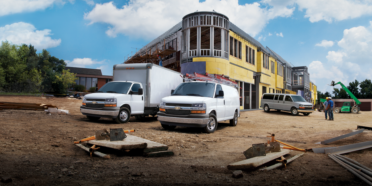 Various Chevy Commercial Vehicles Parked At Construction Site Together