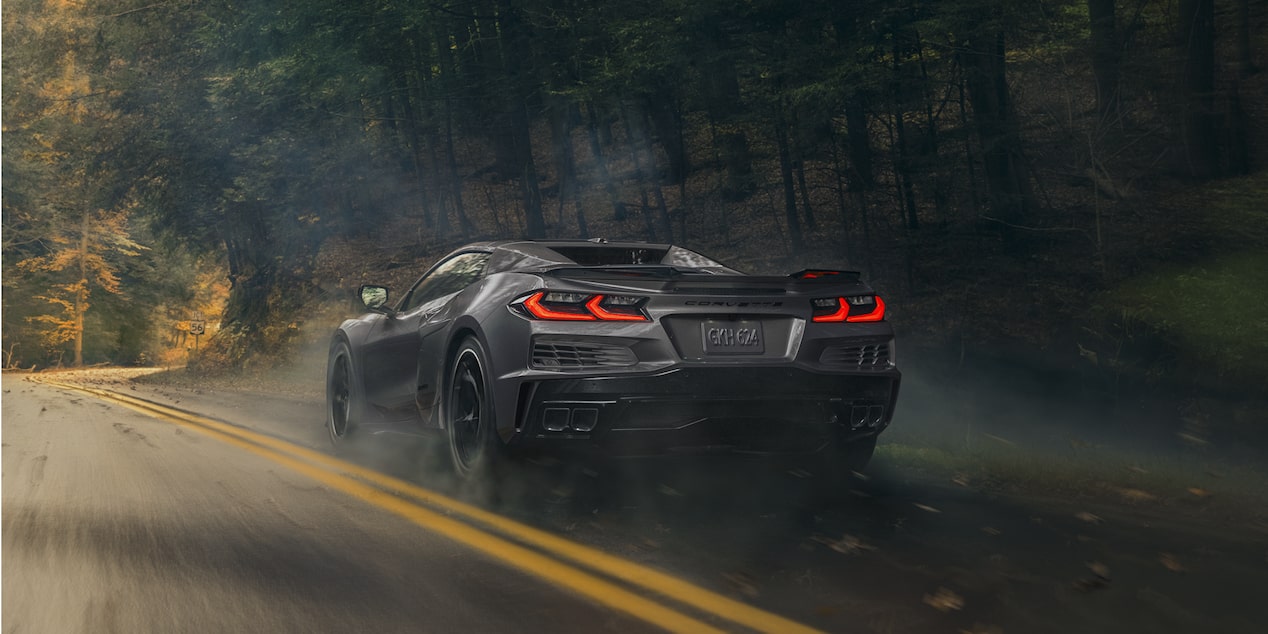 Three Quarters Rear View of a Gray Chevy Corvette E-Ray Going Down the Road