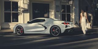 Woman Walking Up to a 2025 Corvette Stingray with Shopping Bags