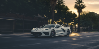 White 2025 Chevrolet Stingray Driving Downtown