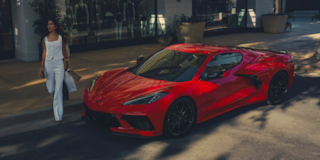 Woman Walking Up to a 2025 Corvette Stingray with Shopping Bags