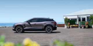 Side View of a Gray Chevy Blazer EV in Front of a Beach