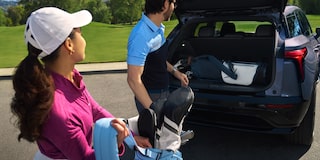 A Man and a Woman Putting Things in the Trunk of a 2025 Chevy Blazer EV