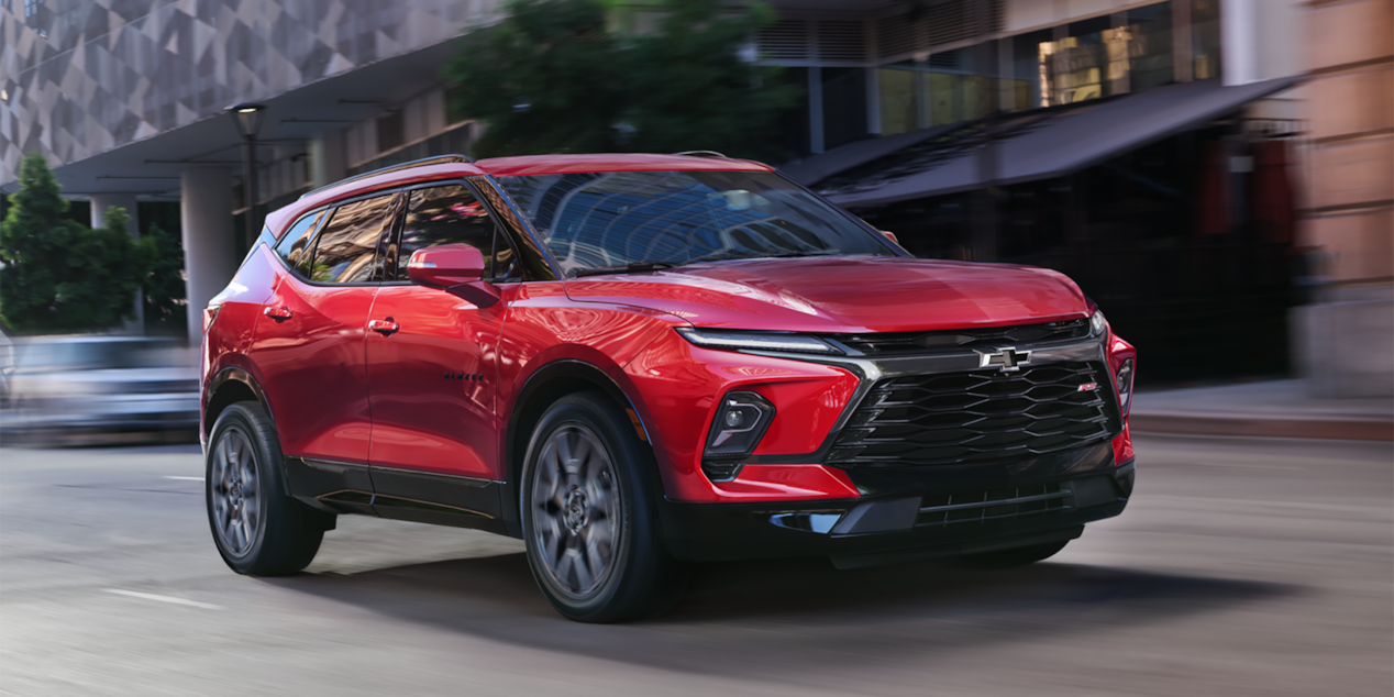 Red 2025 Chevy Blazer Driving Through a Downtown