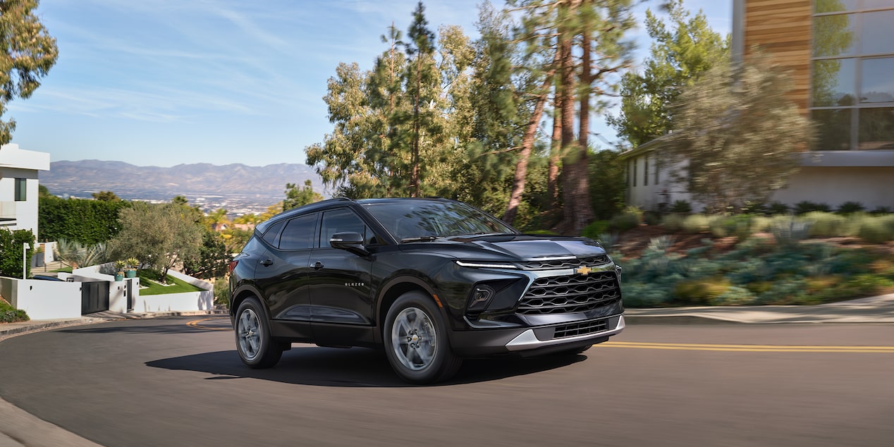 A Black 2025 Chevy Blazer Parked Next to a Building on a Sunny Day