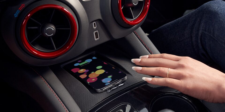 Woman Using Wireless Smart Phone Charging Inside the 2025 Chevy Blazer