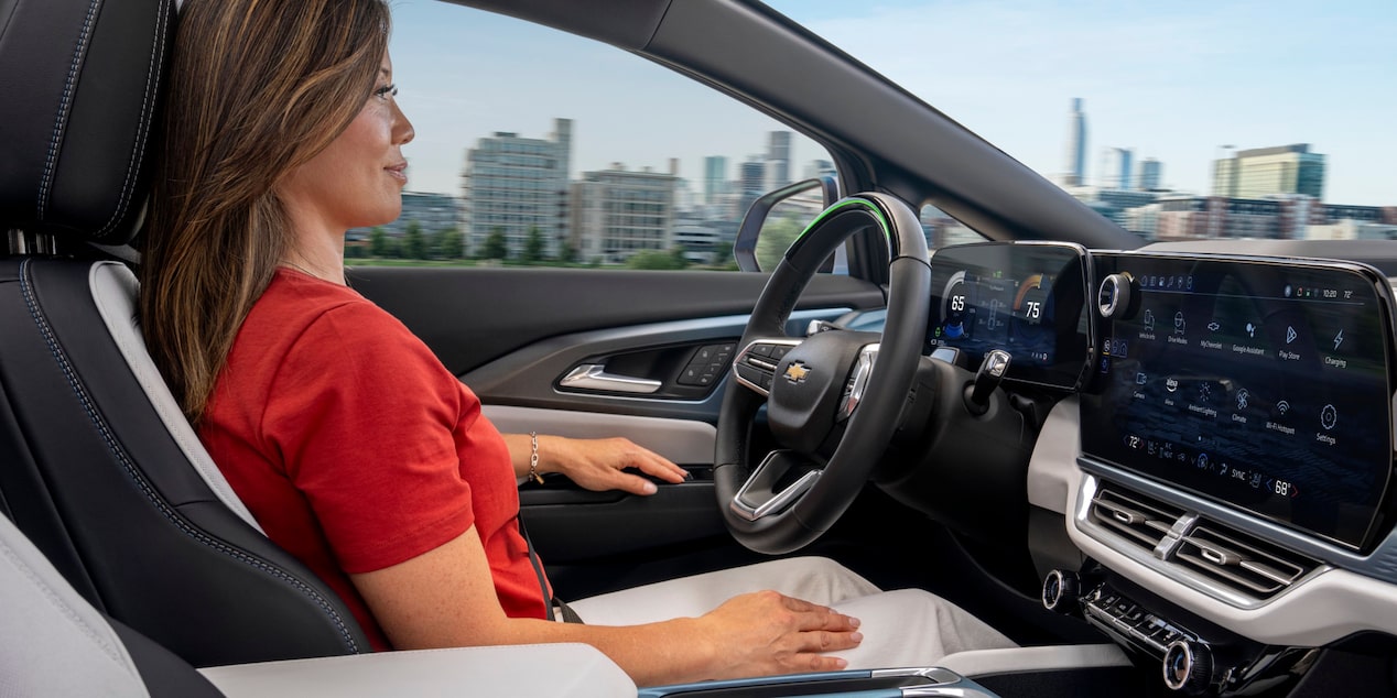 Side Passenger View of a Woman Sitting in the Driver’s Seat of 2025 Chevy Equinox EV
