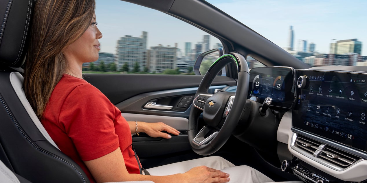 Side Passenger View of a Woman Sitting on the Driver’s Seat of 2025 Chevy Equinox EV