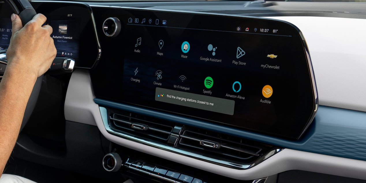 Close-up of the Dashboard Monitor of a 2025 Chevy Equinox EV with a Hand of the Steering Wheel