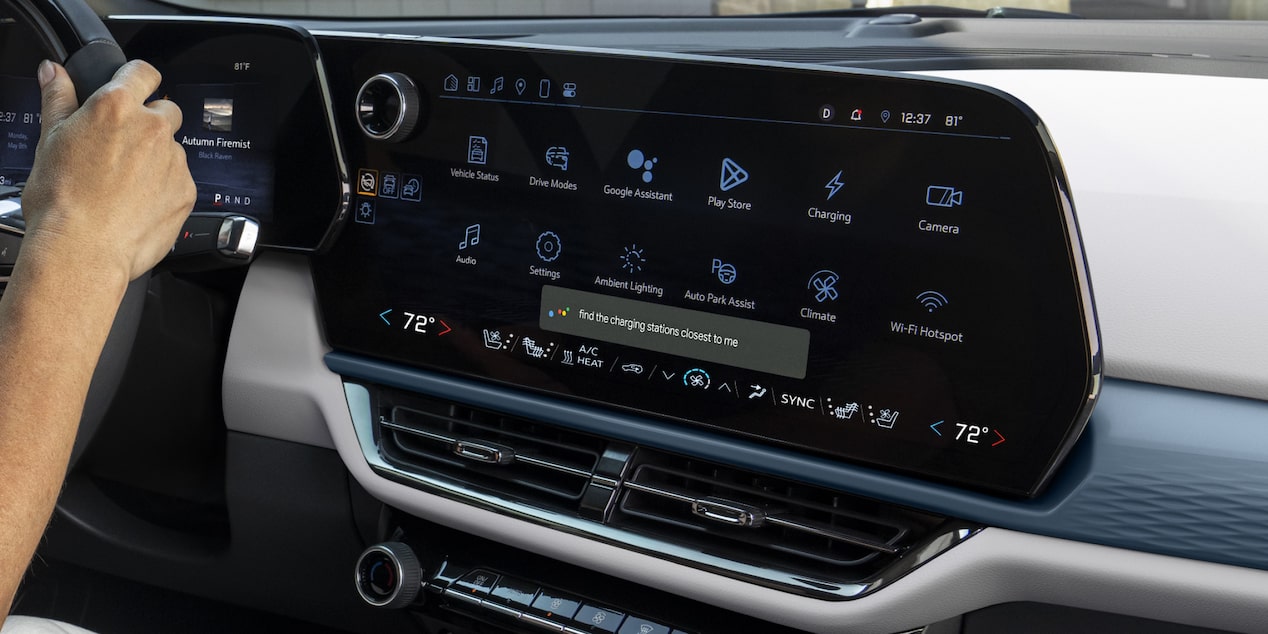 Close-up of the Dashboard Monitor of a 2025 Chevy Equinox EV with a Hand of the Steering Wheel