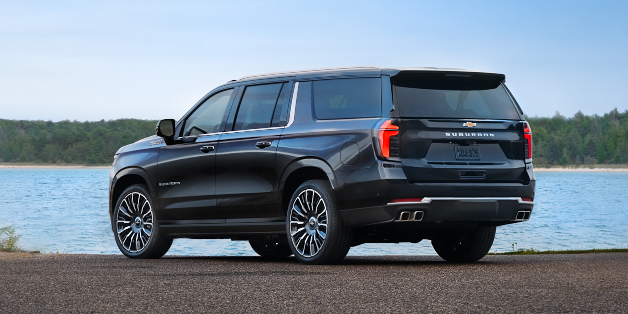 Rear Three-Quarters View of the 2025 Chevrolet Suburban SUV Parked Near a Lake