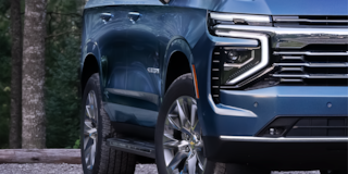 Close-up of the 2025 Chevrolet Suburban's Passenger Side Parked in a Wooded Area