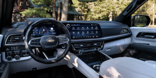 Driver's View of the Front Dashboard, Steering Wheel, and Infotainment System in the 2025 Chevrolet Suburban SUV