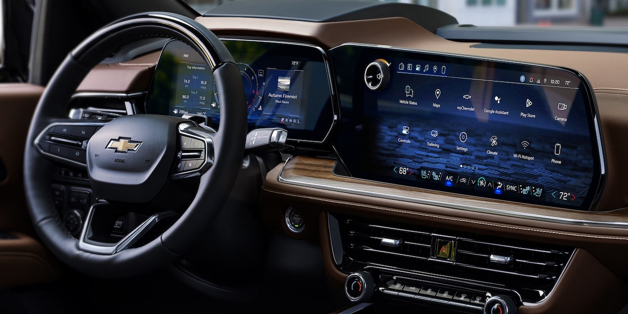 Three-quarters Passenger View of the 2025 Chevrolet Suburban Driving Through a Beautiful Neighborhood 