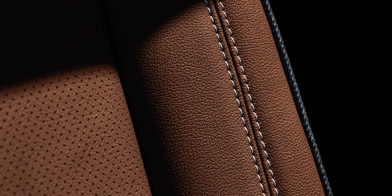 Close-Up View of Stiching on Brown Leather Seats Inside the 2025 Chevy Suburban