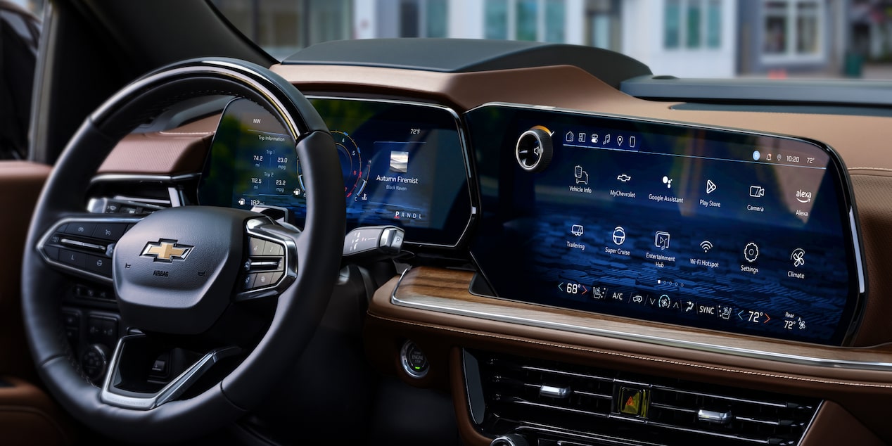 Three-quarters Passenger View of the 2025 Chevrolet Suburban Driving Through a Beautiful Neighborhood 
