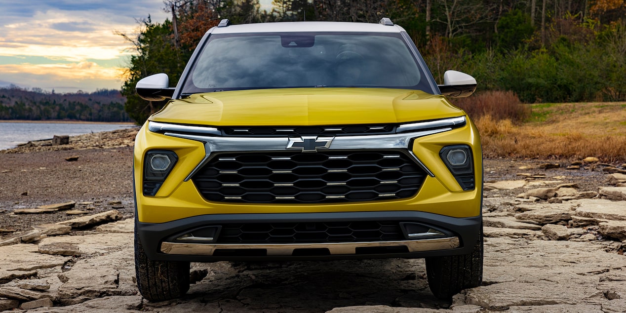 The Redesigned Fascia and Grille of the Trailblazer Parked Along a Woodland Coast