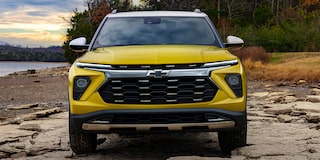 The Redesigned Fascia and Grille of the Trailblazer Parked Along a Woodland Coast