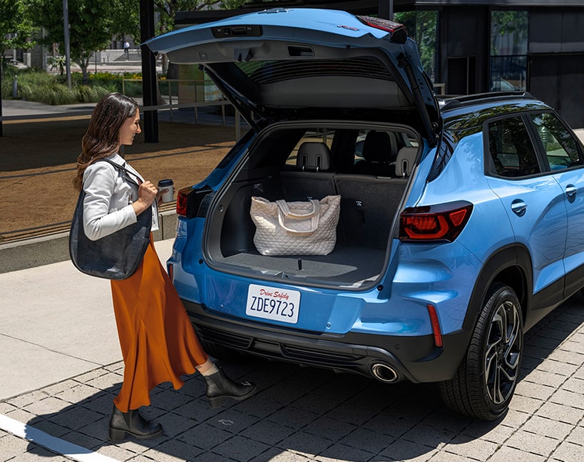 A Woman Loading Her Bag in the Trunk of the 2025 Chevy Trailblazer