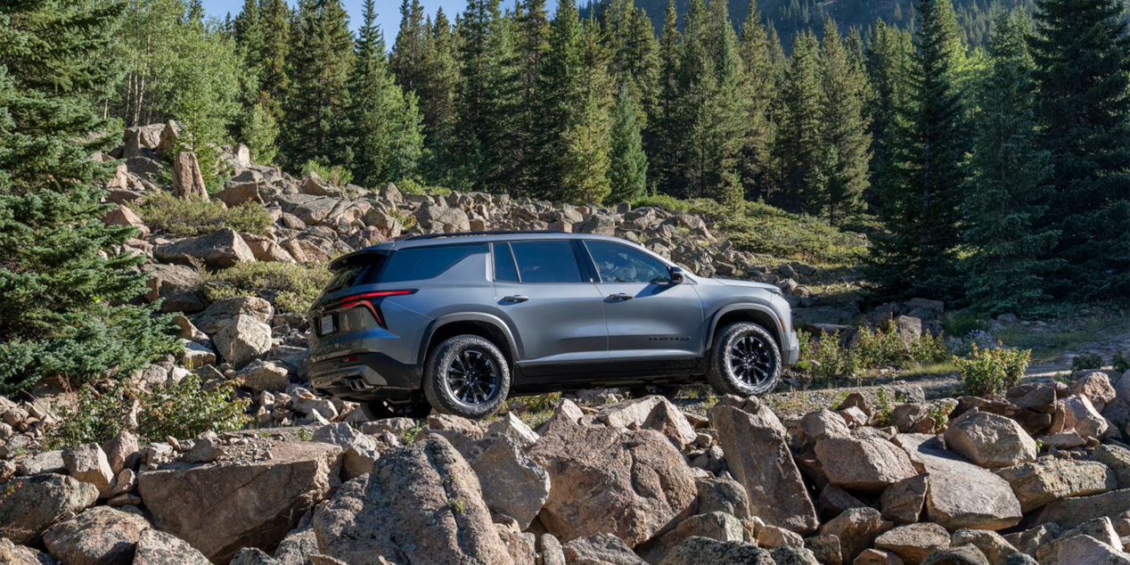 Side View of a Silver Chevy Traverse in a Beautiful Natural Park