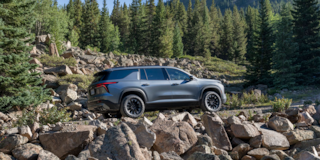 Side View of a Silver Chevy Traverse in a Beautiful Natural Park