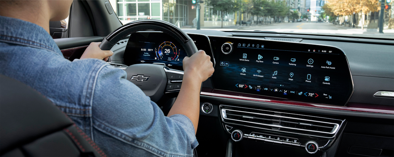 A Man in the Driver’s Seat of 2025 Chevy Traverse Holding the Steering Wheel