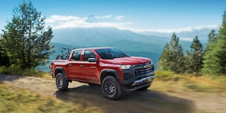 The 2025 Chevy Colorado Driving up a Cliff Side on a Beautiful Day